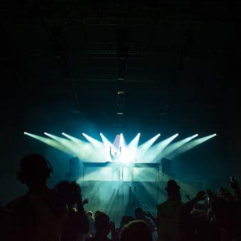 DJ electrifying the club with vibrant lights and energetic beats, captivating the lively crowd.